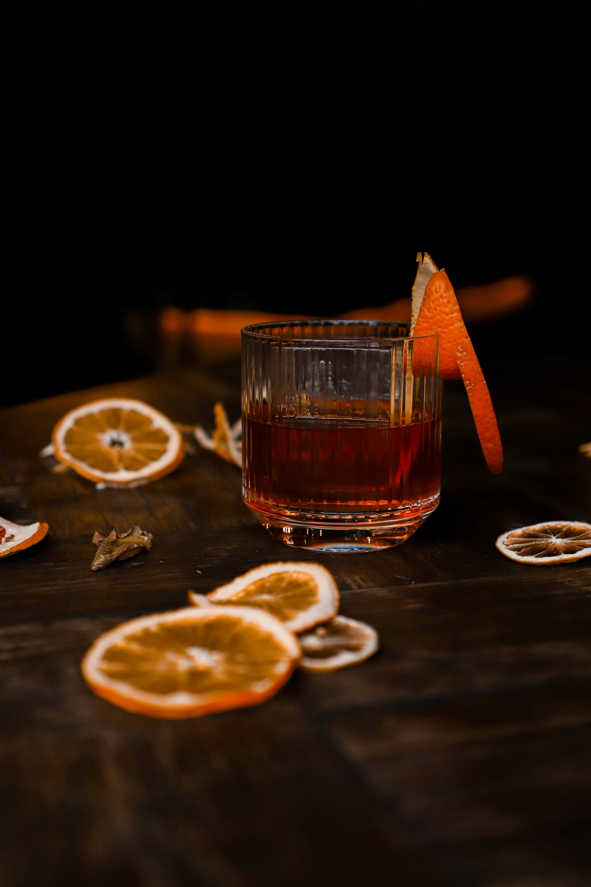 Närbild på Negroni drink med Campari, vermouth och gin – serverad med apelsinzest i lågt glas